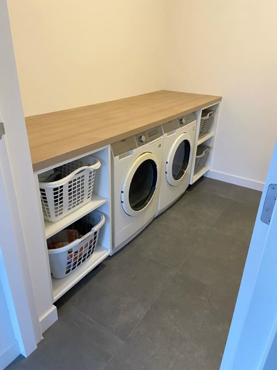 In-room laundry area with washing machines in a serviced apartment building