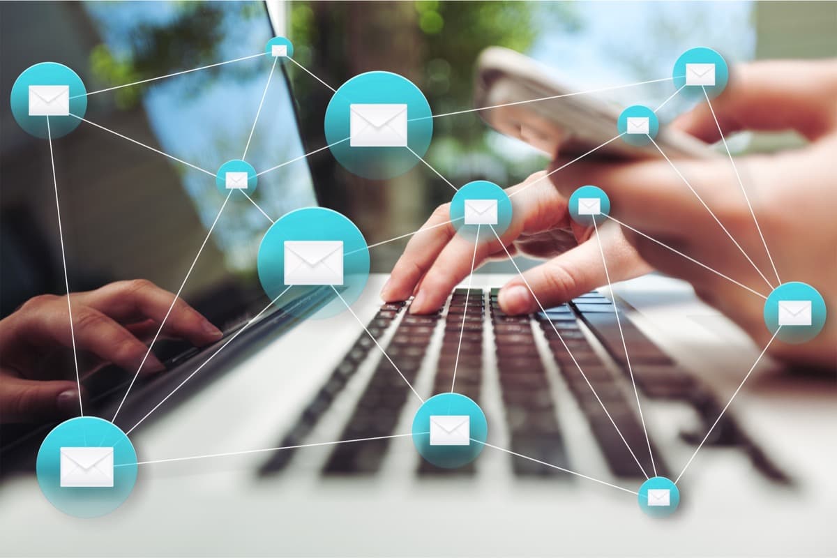 Travel manager messaging property providers on a laptop