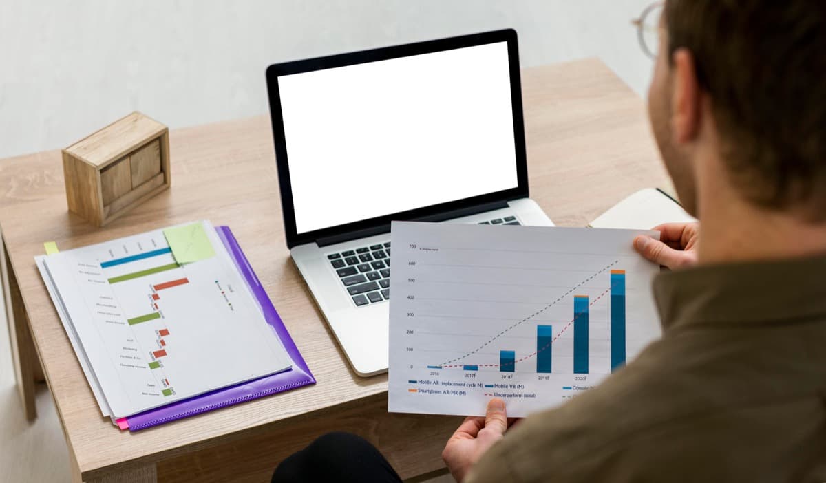 Travel manager reviewing booking statistics and export reports