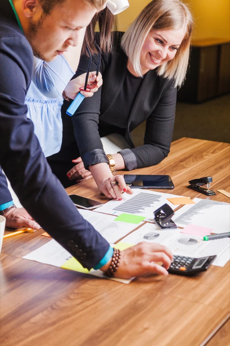 Accounting team reconciling corporate travel invoices at a meeting table