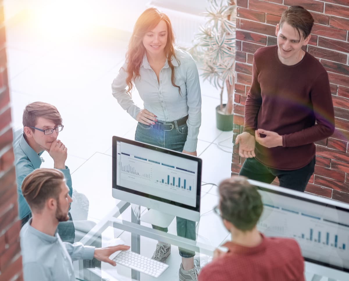 Travel managers reviewing group booking reports and analytics on screen