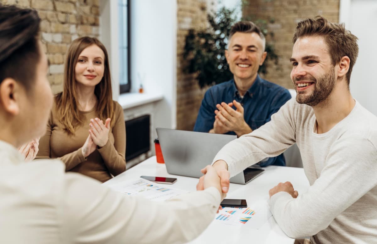 Business partners negotiating group accommodation rates at a meeting table