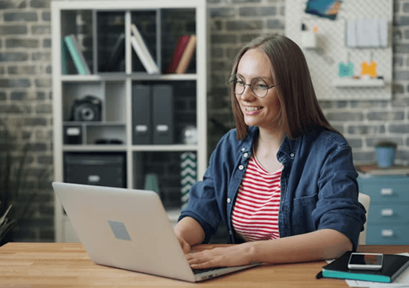 Travel manager coordinating corporate travel at a laptop