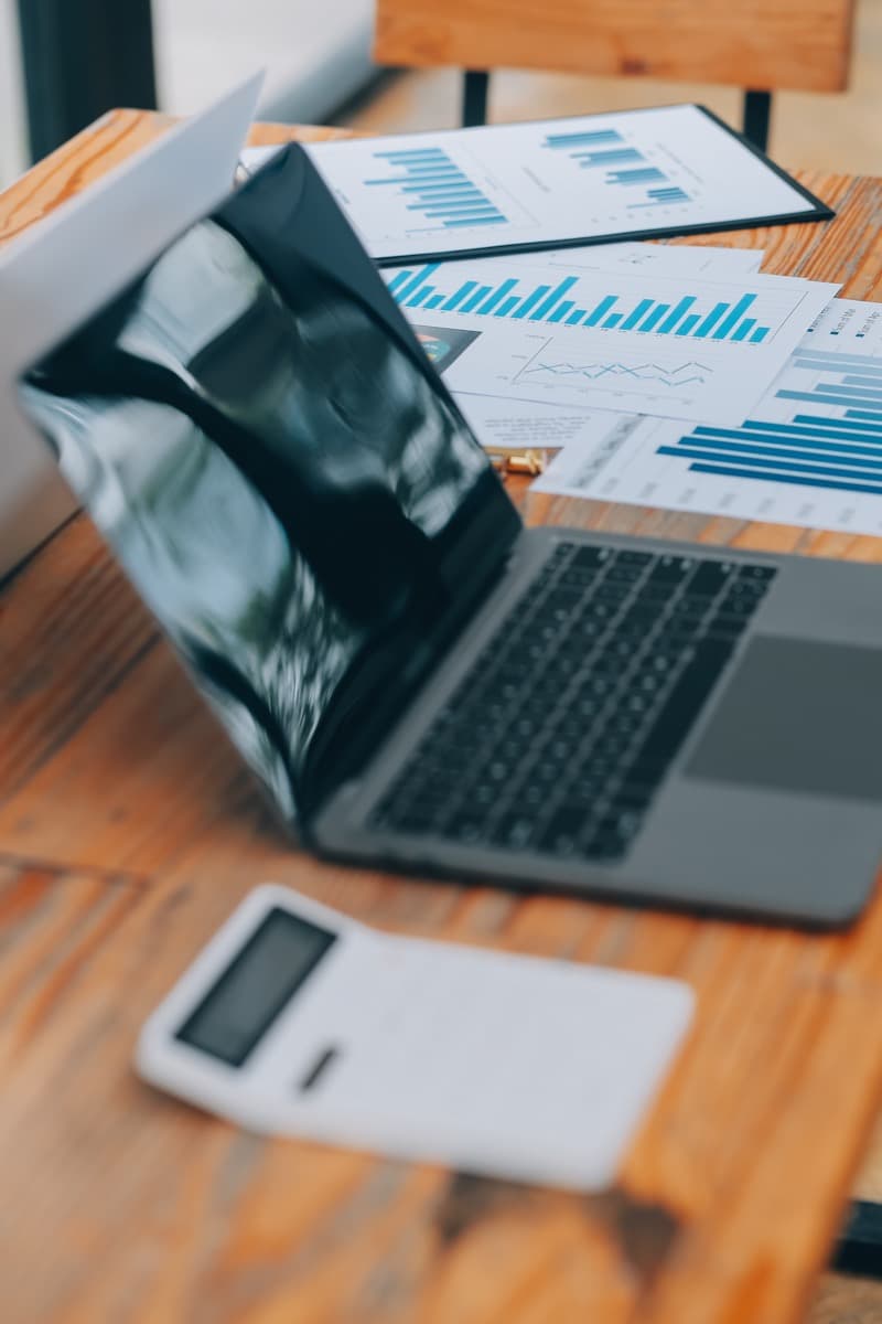 Finance professional reviewing corporate accommodation reports on a laptop