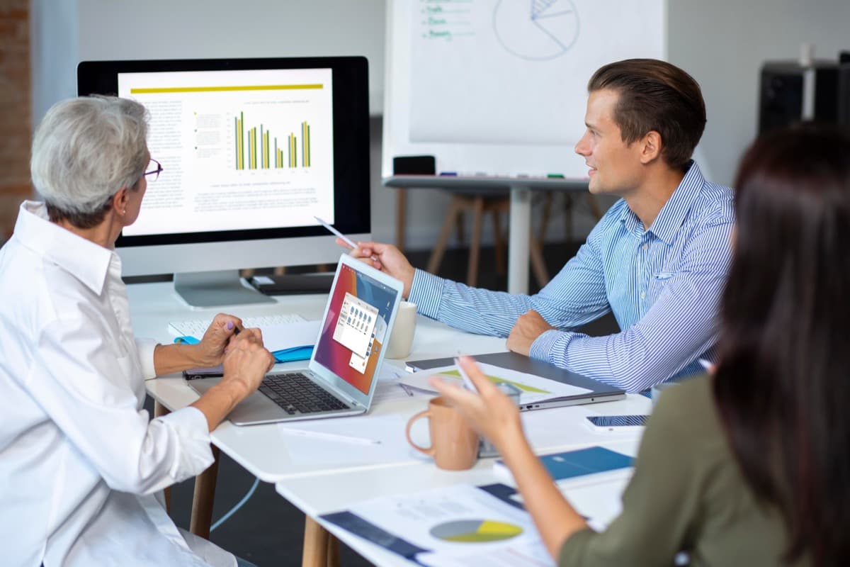 Corporate team reviewing accommodation strategy on a large monitor