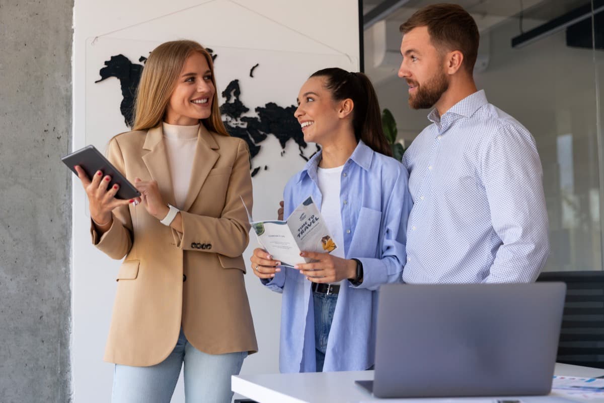Corporate team reviewing accommodation options together on a laptop