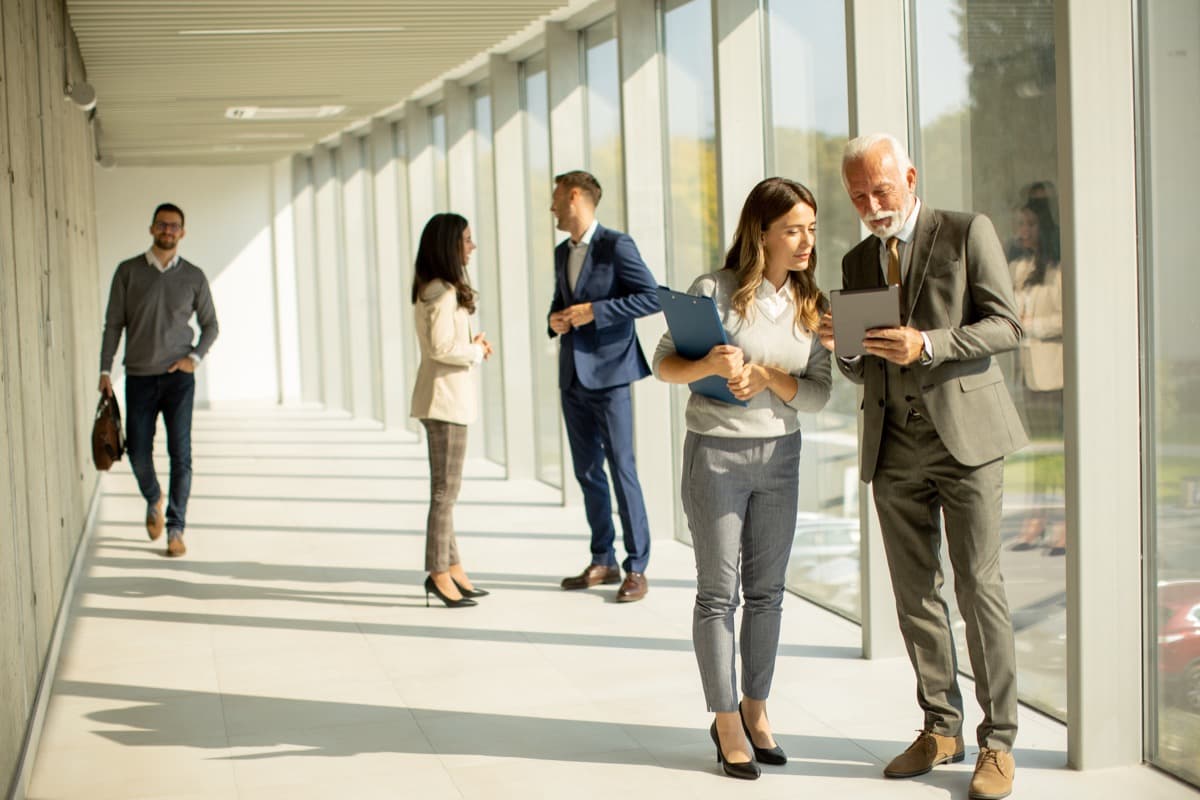 Corporate team collaborating in a modern serviced apartment workspace