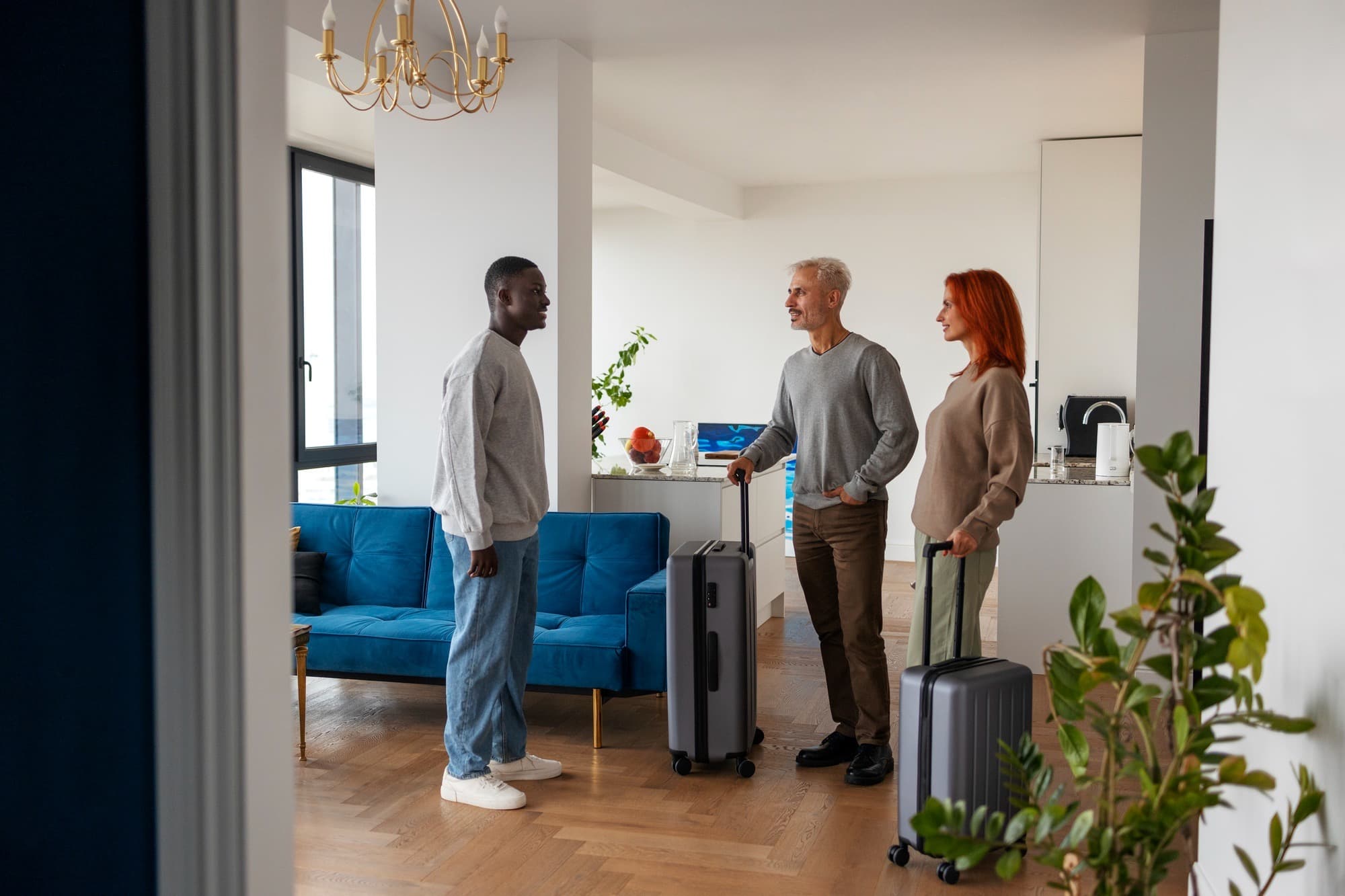 Relocating professionals with luggage in a furnished corporate apartment