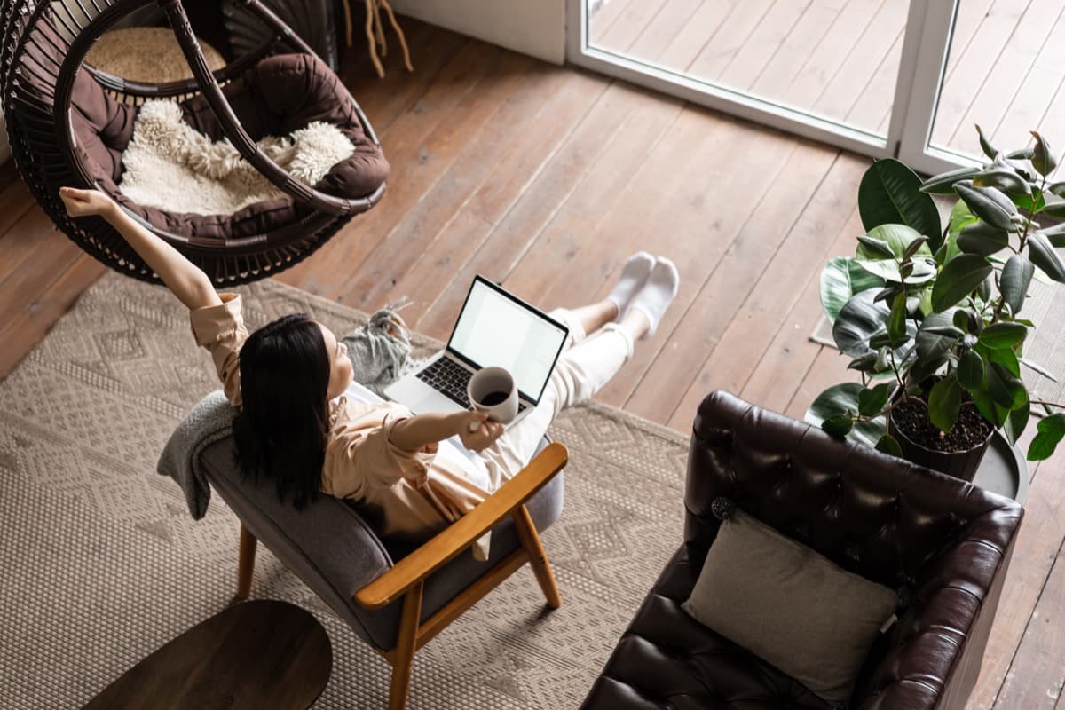 Relocating employee working on a laptop in a comfortable furnished apartment