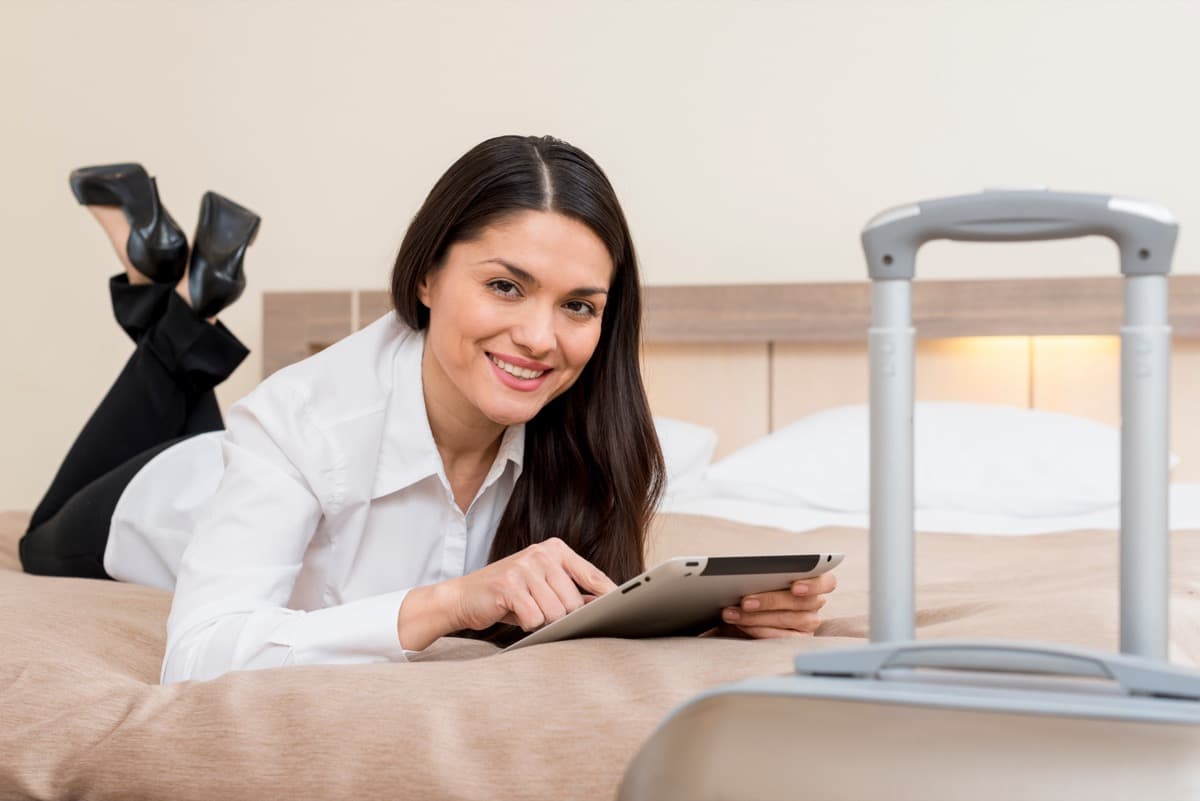 Guest browsing local tours and experiences on a tablet in a OnePlace apartment