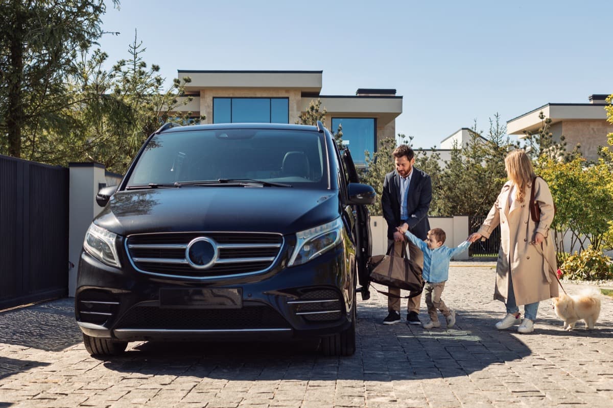 Family arriving at accommodation with shuttle transport from local services