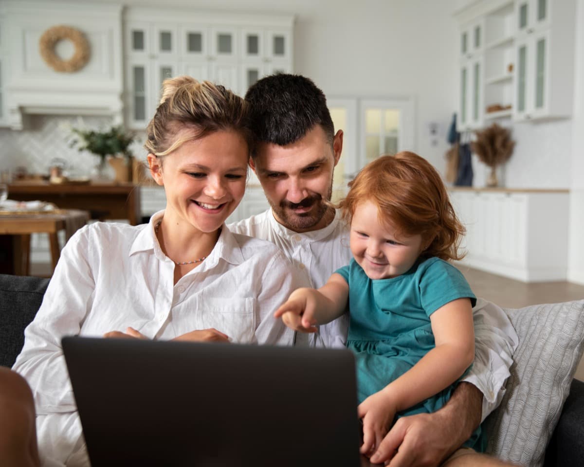 Family reviewing accommodation options together on a laptop