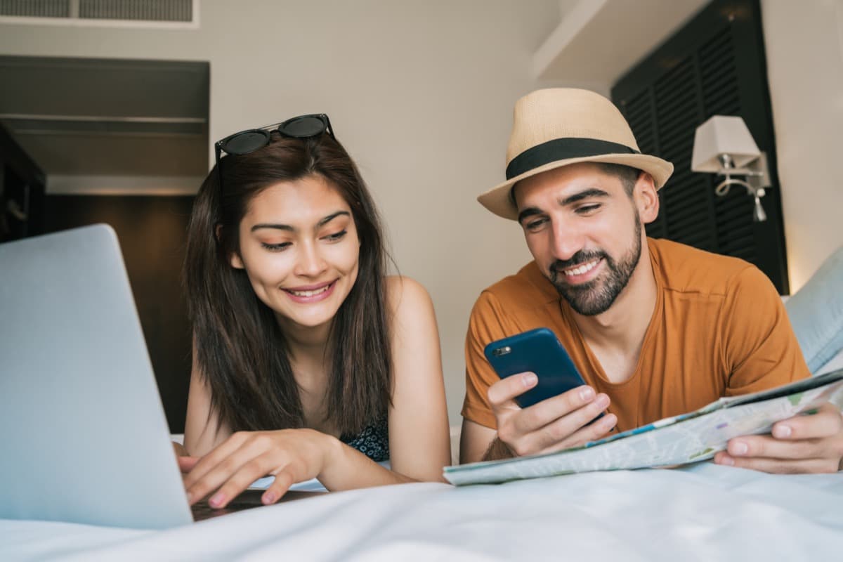 Holiday travellers comparing accommodation options on a smartphone