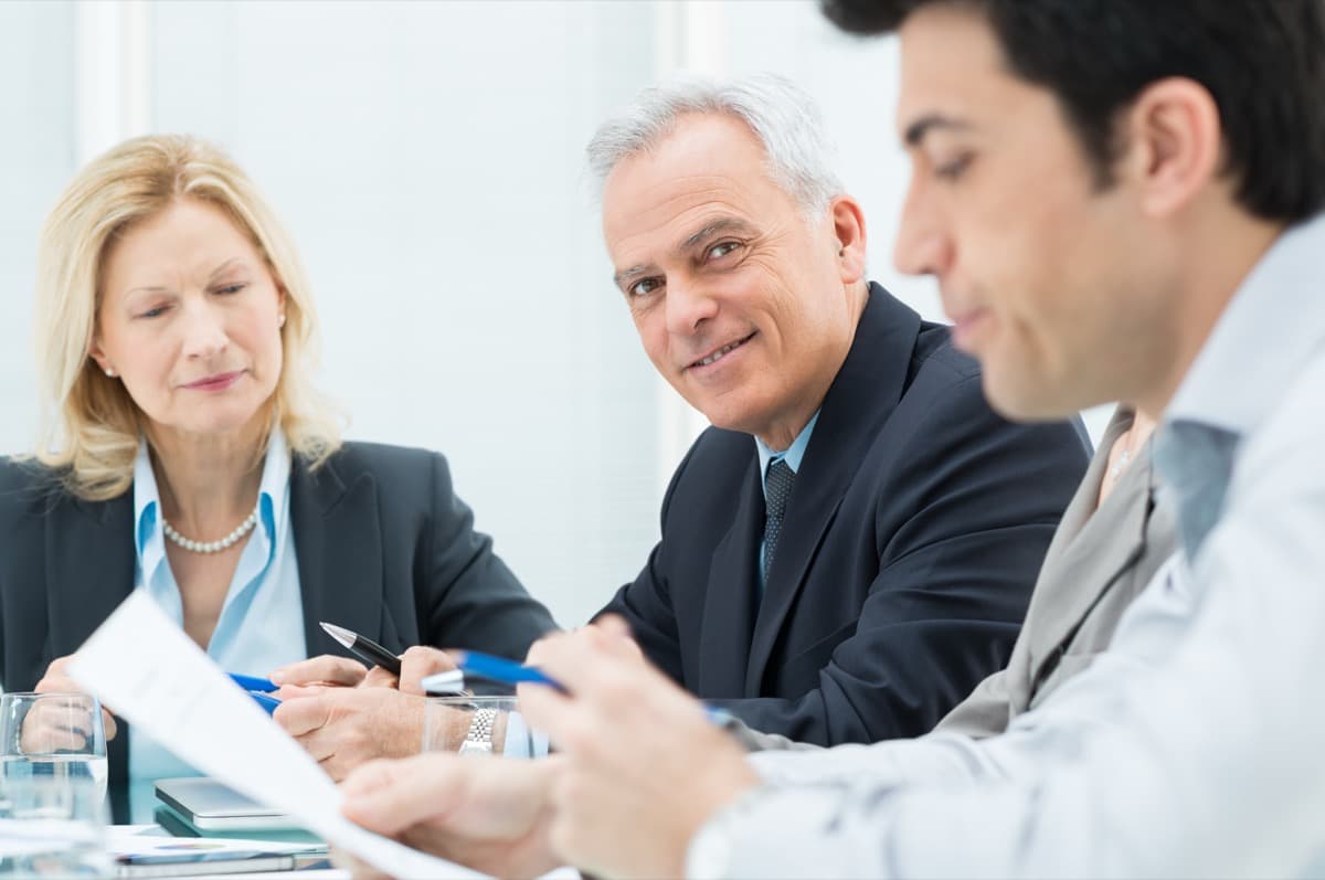 HR and mobility managers reviewing compliance documentation in a meeting
