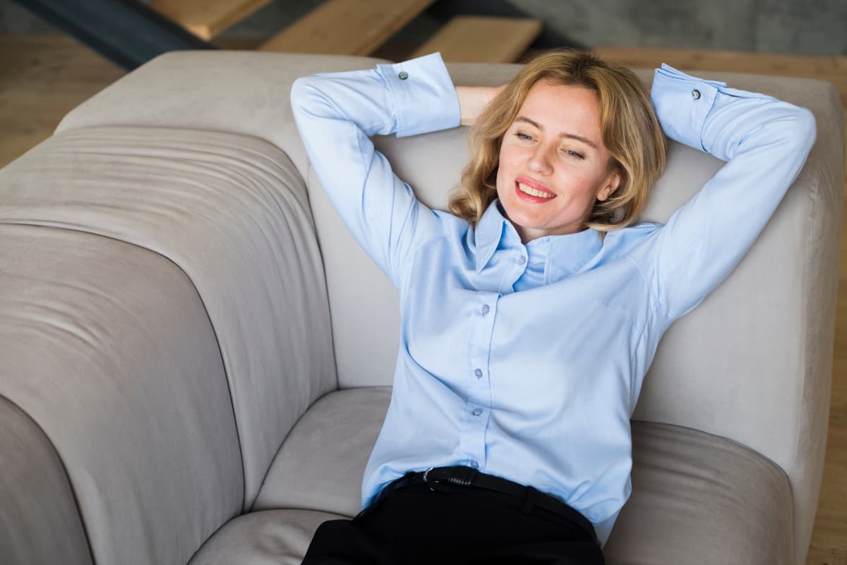 Individual relaxing on a sofa in a comfortable serviced apartment