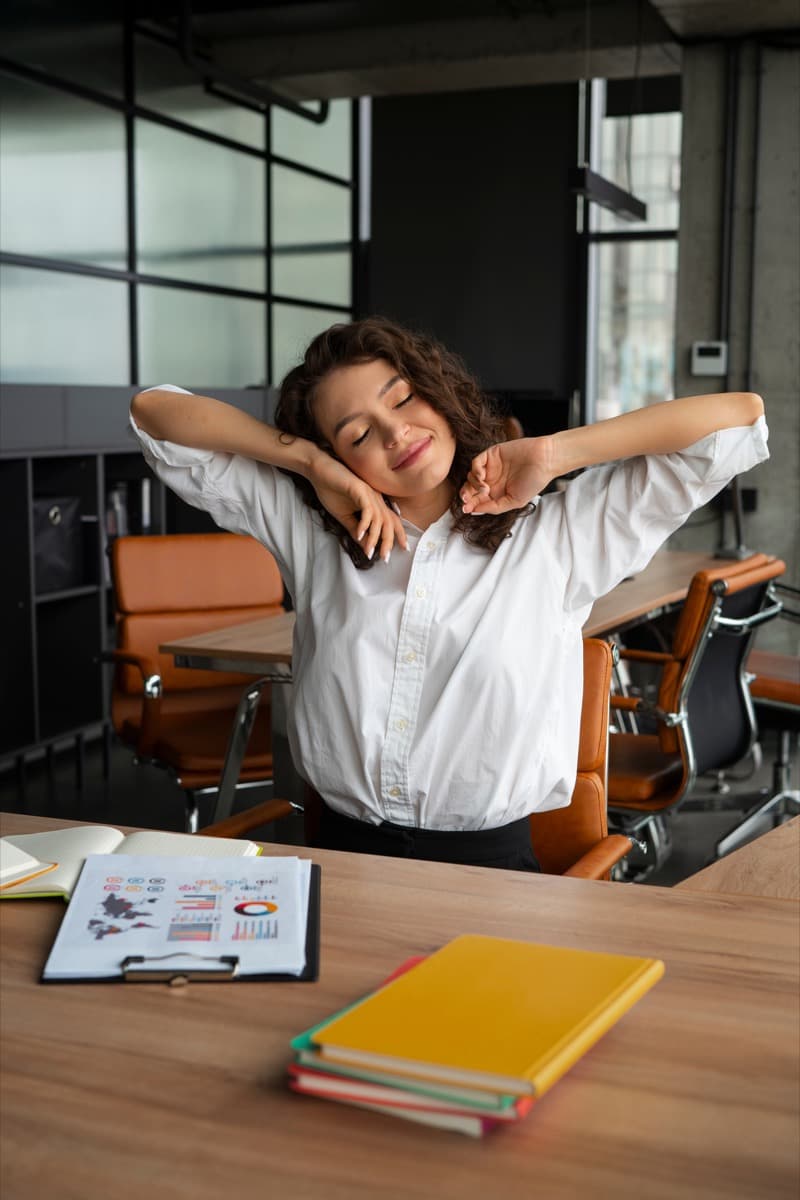 Individual stretching at a desk in a safe, reliable work-friendly apartment