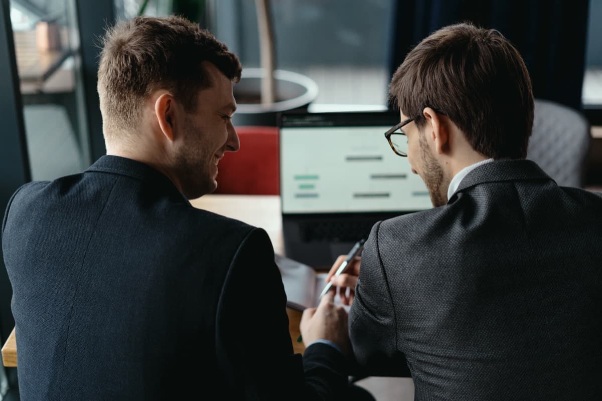 Marketing partners reviewing campaign performance on a computer screen