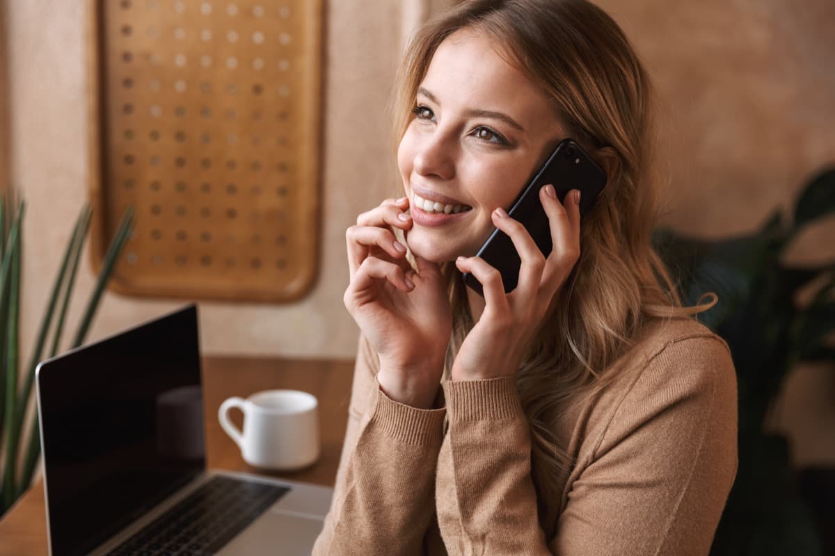 Caregiver coordinating medical stay support on the phone at their accommodation