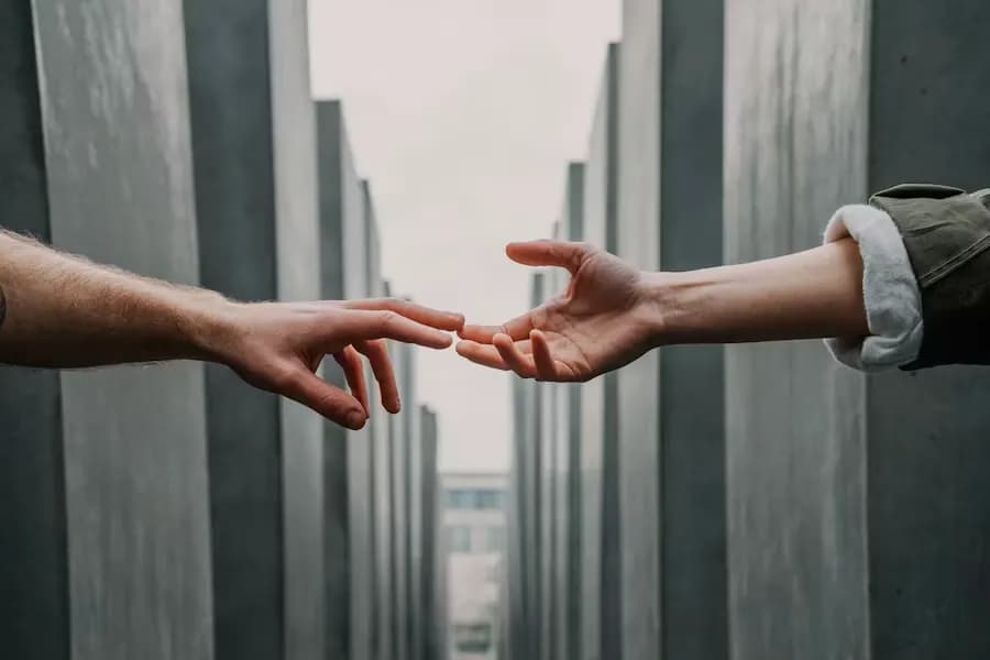 Two hands reaching toward each other