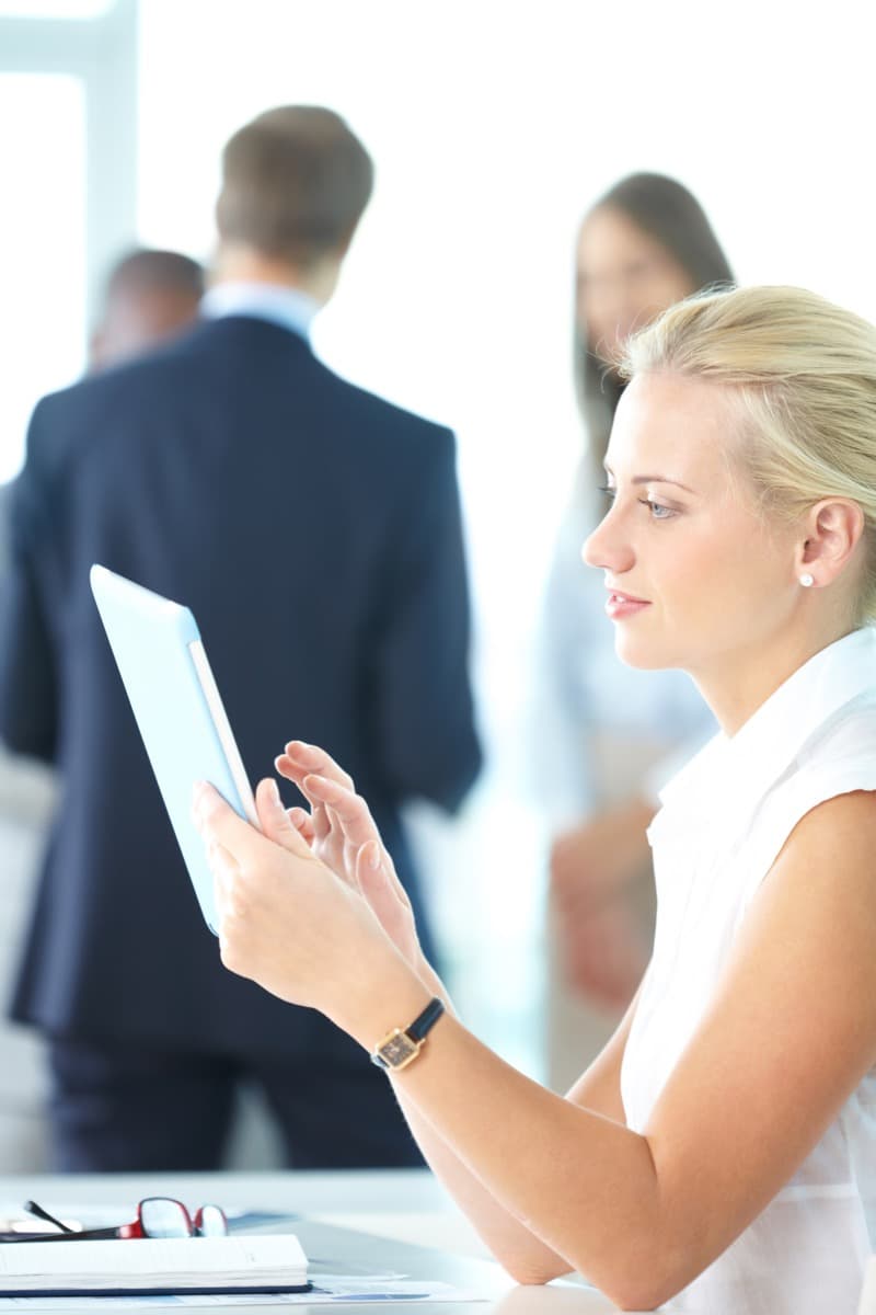 Relocation specialist generating client housing spend reports on a laptop