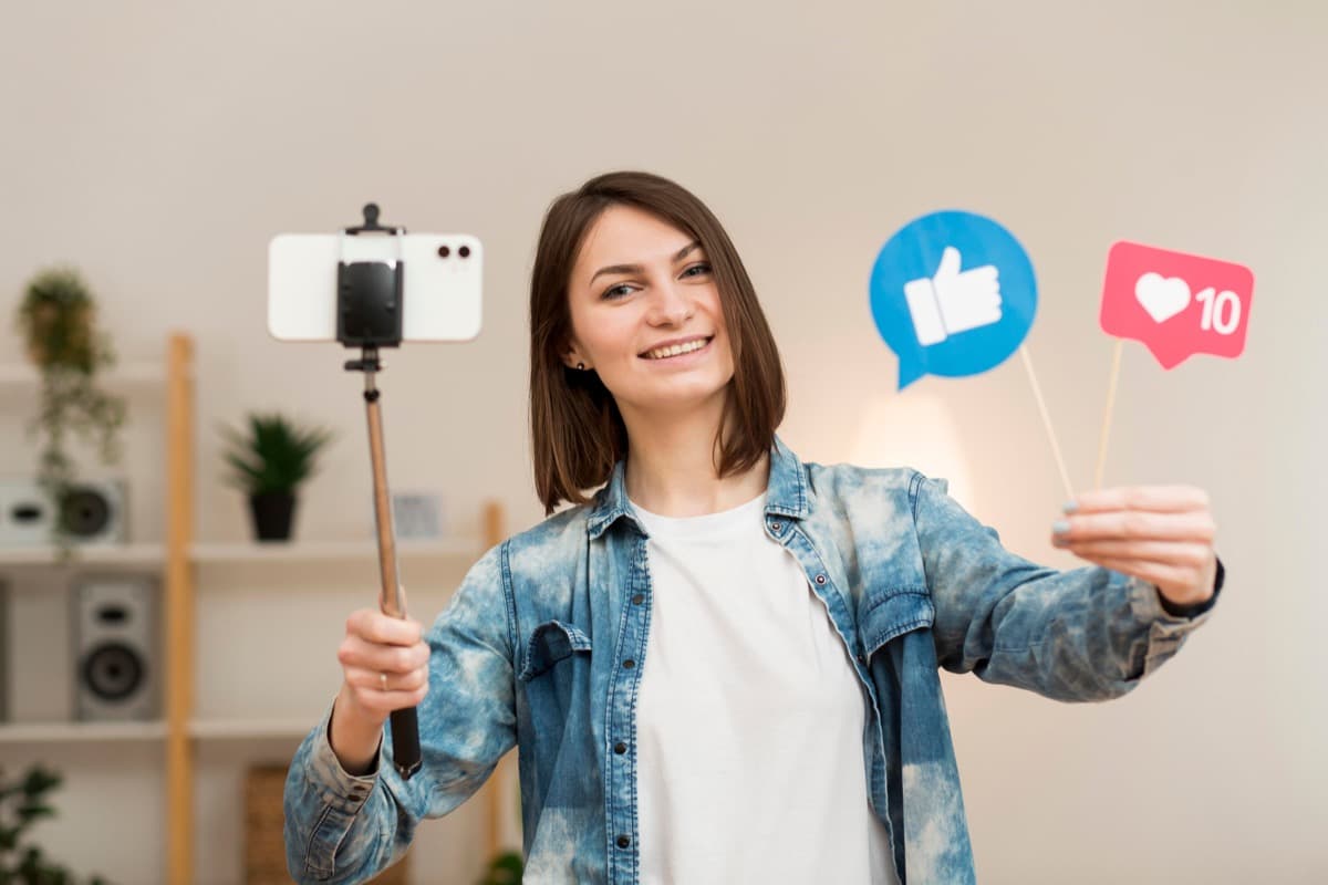 Influencer recording social media content with a smartphone on a gimbal